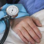 Close up; hands taking blood pressure