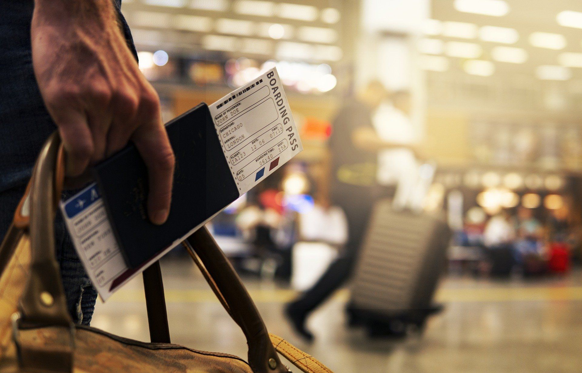 O persoană care ține un bilet de avion în mână, în aeroport